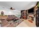 Open living room featuring a fireplace with bookshelves, tile flooring, and modern decorations and furniture at 1580 Rosita Dr, Las Vegas, NV 89123