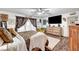 Spacious bedroom featuring wood floors, a ceiling fan, and a large window at 1580 Rosita Dr, Las Vegas, NV 89123