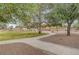 A walking path winds through a green park with mature trees and landscaping at 1580 Rosita Dr, Las Vegas, NV 89123