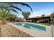 A refreshing backyard pool alongside a desert landscaped area and an outdoor living space at 1580 Rosita Dr, Las Vegas, NV 89123