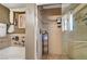 Bathroom shower with a glass door and tile surround with built-in shelving at 1580 Rosita Dr, Las Vegas, NV 89123