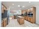 Spacious kitchen with stainless steel appliances, wood cabinets, a center island, and tile flooring at 2385 Orangeburg Pl, Henderson, NV 89044