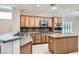 Well-lit kitchen featuring wood cabinets, granite countertops, and stainless steel appliances at 2385 Orangeburg Pl, Henderson, NV 89044