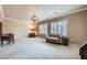 Spacious living room with stylish chandelier, neutral carpet, and plantation shutters at 2385 Orangeburg Pl, Henderson, NV 89044