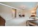 Bright living room featuring a chandelier, plush carpet and a cozy sitting area at 2385 Orangeburg Pl, Henderson, NV 89044