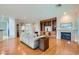 Cozy living room with a fireplace, built-in shelving, and hardwood floors at 2385 Orangeburg Pl, Henderson, NV 89044