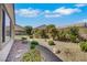 Low maintenance backyard featuring rock ground cover, bushes and small trees at 2580 Flare Star Dr, Henderson, NV 89044
