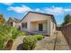 A backyard features desert landscaping and sliding glass doors leading indoors at 2580 Flare Star Dr, Henderson, NV 89044