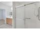 Shower with grab bars in bathroom with tile floor and light wood cabinets at 2580 Flare Star Dr, Henderson, NV 89044