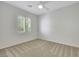 Bright bedroom featuring a window, ceiling fan and neutral carpet at 2580 Flare Star Dr, Henderson, NV 89044