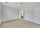 Spacious bedroom with neutral carpet, ceiling fan, and doorway to the Primary bathroom at 2580 Flare Star Dr, Henderson, NV 89044
