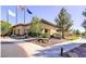 Exterior view of the clubhouse with flags, landscaping, and a welcoming entrance at 2580 Flare Star Dr, Henderson, NV 89044
