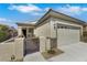 A single-story home features a gated courtyard and a two-car garage with decorative windows at 2580 Flare Star Dr, Henderson, NV 89044