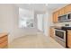 The kitchen features tile floors and stainless steel appliances that flow into the living area at 2580 Flare Star Dr, Henderson, NV 89044