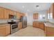 An open kitchen features stainless steel appliances, light wood cabinets, and lots of storage at 2580 Flare Star Dr, Henderson, NV 89044