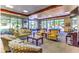 Comfortable lounge area with couches, pool tables, and large windows overlooking greenery at 2580 Flare Star Dr, Henderson, NV 89044