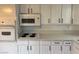 A cozy kitchen with sleek countertops, white cabinetry, and modern appliances at 259 E Van Wagenen St # 259, Henderson, NV 89015