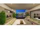 Inviting courtyard with a cozy seating area and fire pit, complemented by stylish landscaping and seamless indoor-outdoor flow at 2630 Juniper Branch St, Las Vegas, NV 89117
