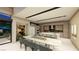 Open-concept living space with dining table, kitchen island, and seamless indoor-outdoor flow at 2630 Juniper Branch St, Las Vegas, NV 89117