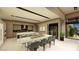 Open-concept living space with dining table, kitchen island, and wine storage at 2630 Juniper Branch St, Las Vegas, NV 89117