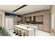 Modern kitchen with a large island, seating, stainless steel appliances, and wood grain cabinets at 2630 Juniper Branch St, Las Vegas, NV 89117