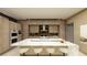 Modern kitchen features wooden cabinets, a marble island, and sleek, built-in appliances at 2630 Juniper Branch St, Las Vegas, NV 89117