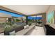 Stylish living room with large glass doors that overlook the pool and outdoor lounge at 2630 Juniper Branch St, Las Vegas, NV 89117