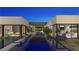 Stunning home showcasing a long pool, connecting various living spaces with lush landscaping, creating a cohesive and luxurious design at 2630 Juniper Branch St, Las Vegas, NV 89117