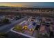 Aerial view showcasing the beautiful home and its surrounding desert landscape at twilight at 3012 Joy Meadow Ave, Henderson, NV 89074