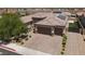Aerial view of a home with a three car garage, brick paved driveway, and low maintenance desert landscaping at 3012 Joy Meadow Ave, Henderson, NV 89074