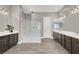 Elegant bathroom featuring a large, glass-enclosed shower and dual vanities with modern fixtures and spacious counter tops at 3012 Joy Meadow Ave, Henderson, NV 89074