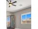 Bedroom featuring a ceiling fan, neutral walls, white trim, and ample natural light at 3012 Joy Meadow Ave, Henderson, NV 89074