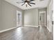 Bright and airy bedroom with wood-look tile flooring and access to the backyard at 3012 Joy Meadow Ave, Henderson, NV 89074