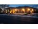Charming single-story home with a brick driveway, a two-car garage and inviting outdoor lighting at 3012 Joy Meadow Ave, Henderson, NV 89074