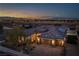 Stunning home with a three-car garage and beautiful desert landscaping at dusk at 3012 Joy Meadow Ave, Henderson, NV 89074