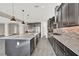 Contemporary kitchen featuring granite countertops, an island, gray cabinets, and stainless steel appliances at 3012 Joy Meadow Ave, Henderson, NV 89074