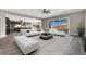 Modern living room open to a contemporary kitchen, with a sliding glass door leading to the backyard at 3012 Joy Meadow Ave, Henderson, NV 89074
