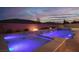 Beautiful outdoor pool with waterfalls and ambient lighting, perfect for evening relaxation at 3012 Joy Meadow Ave, Henderson, NV 89074