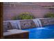 Beautiful backyard pool featuring waterfall features, detailed tile, and mature landscaping at 3012 Joy Meadow Ave, Henderson, NV 89074