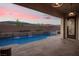 Outdoor pool at dusk with waterfalls and decorative lighting features for a relaxing ambiance at 3012 Joy Meadow Ave, Henderson, NV 89074