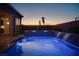 Backyard swimming pool with waterfall feature, a hot tub, and well-maintained landscaping at 3012 Joy Meadow Ave, Henderson, NV 89074