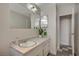 Bright bathroom with marble countertop, large mirror, and a plant at 3220 Pawnee Dr, Las Vegas, NV 89169