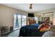 Comfortable bedroom featuring a ceiling fan, access to the pool area through a sliding glass door, and modern decor at 3220 Pawnee Dr, Las Vegas, NV 89169