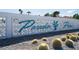 Entrance to the Paradise Palms community featuring a decorative block wall with the community name and cacti at 3220 Pawnee Dr, Las Vegas, NV 89169