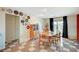 Bright dining area with access to the backyard, featuring a mid-century cabinet, table, and stylish wall decor at 3220 Pawnee Dr, Las Vegas, NV 89169