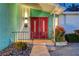 Inviting front entrance featuring a decorative red double door, desert landscaping, and unique exterior lighting at 3220 Pawnee Dr, Las Vegas, NV 89169