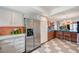 Well-lit kitchen with stainless steel appliances, white cabinetry, and an adjacent peninsula bar with seating at 3220 Pawnee Dr, Las Vegas, NV 89169