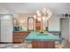 Kitchen island with seating and unique lighting fixtures, complemented by mirrored artwork at 3220 Pawnee Dr, Las Vegas, NV 89169