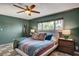 Serene bedroom featuring a ceiling fan, soft lighting, and a large window that illuminates the space at 3220 Pawnee Dr, Las Vegas, NV 89169