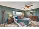 Well-decorated bedroom with a ceiling fan, wood furnishings, and a window offering scenic outdoor views at 3220 Pawnee Dr, Las Vegas, NV 89169